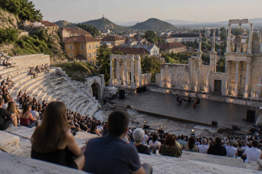 An evening crowd gathered for an open-air performance on the marble seats of the Ancient Theatre of Philippopolis in Plovdiv