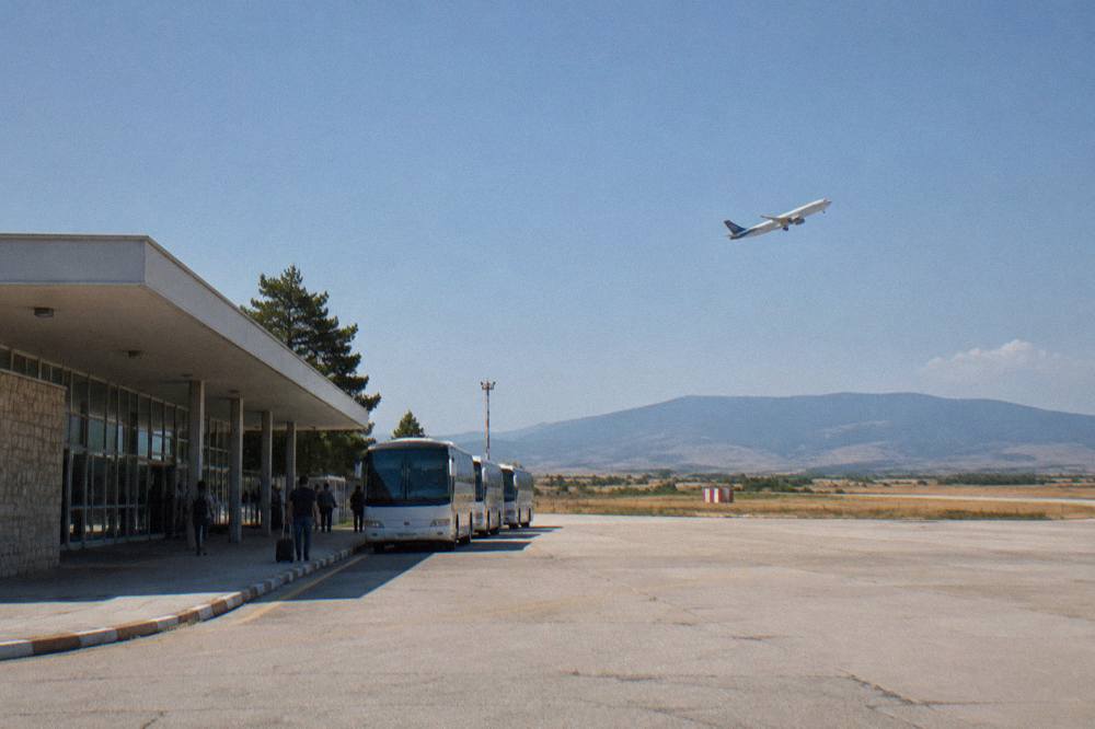 A low-cost passenger aircraft climbing into the sky above fields after takeoff