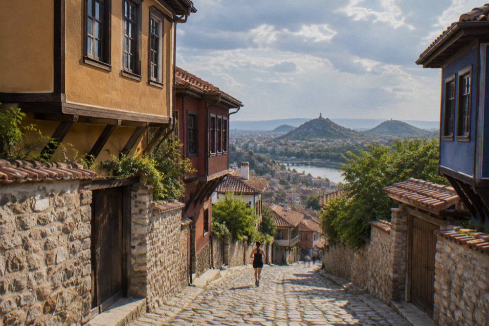 Ancient marble theatre seats overlooking the rooftops of Plovdiv toward distant hills