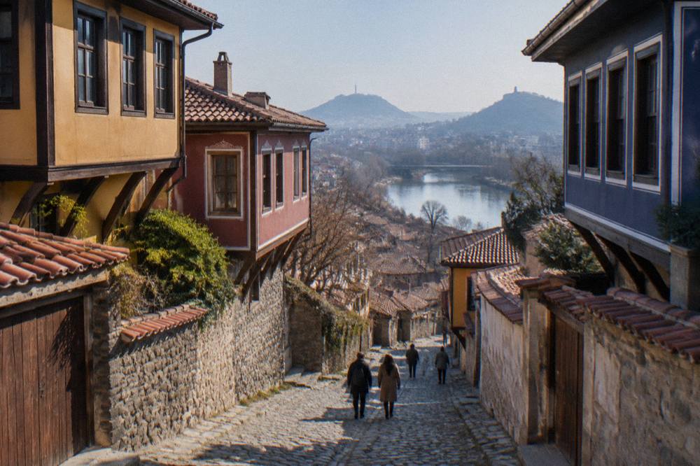 Visitors walking along a cobbled Old Town street in Plovdiv lined with colourful revival-era houses