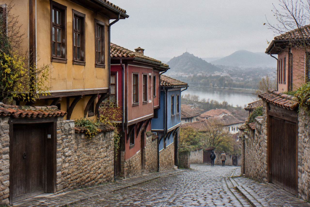 Pastel-coloured revival-era houses on a sloping cobblestone street in Plovdiv Old Town