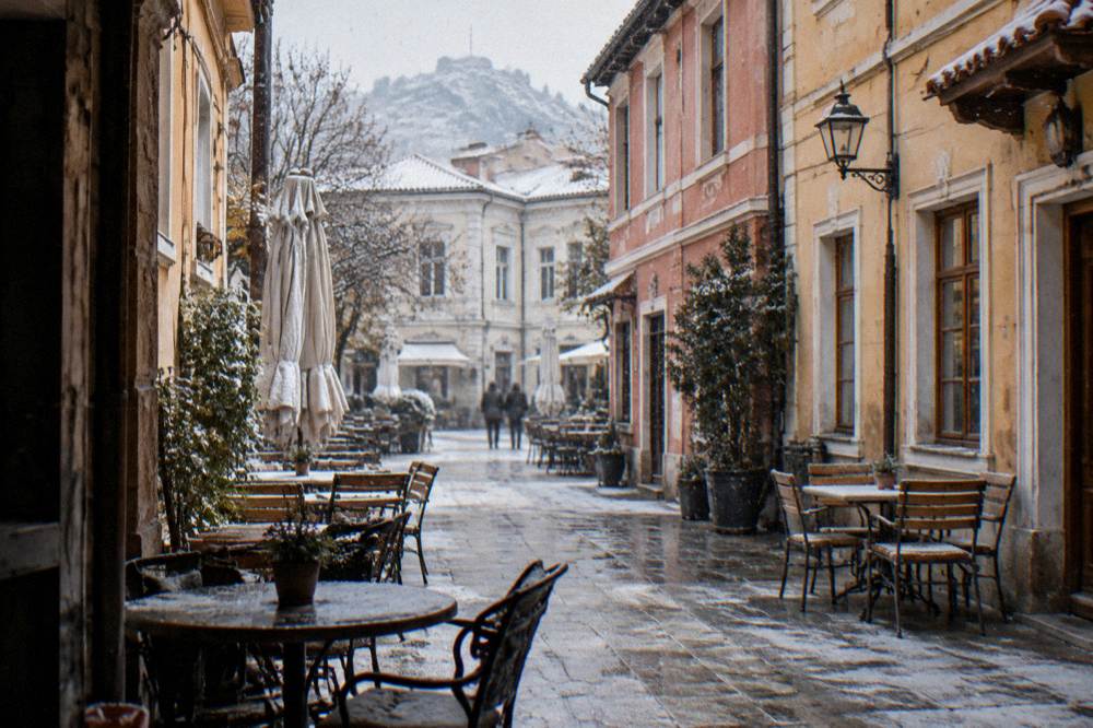 Narrow Kapana pedestrian lane with cafe tables, no people in focus