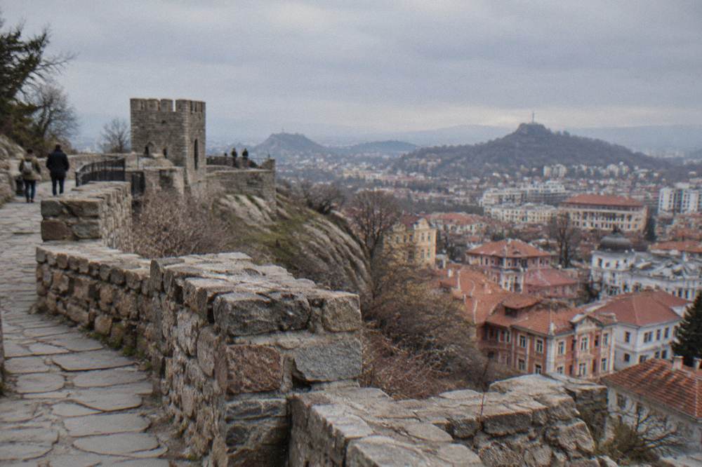 Stone fortification walls and viewpoints on Nebet Tepe above the rooftops of Plovdiv