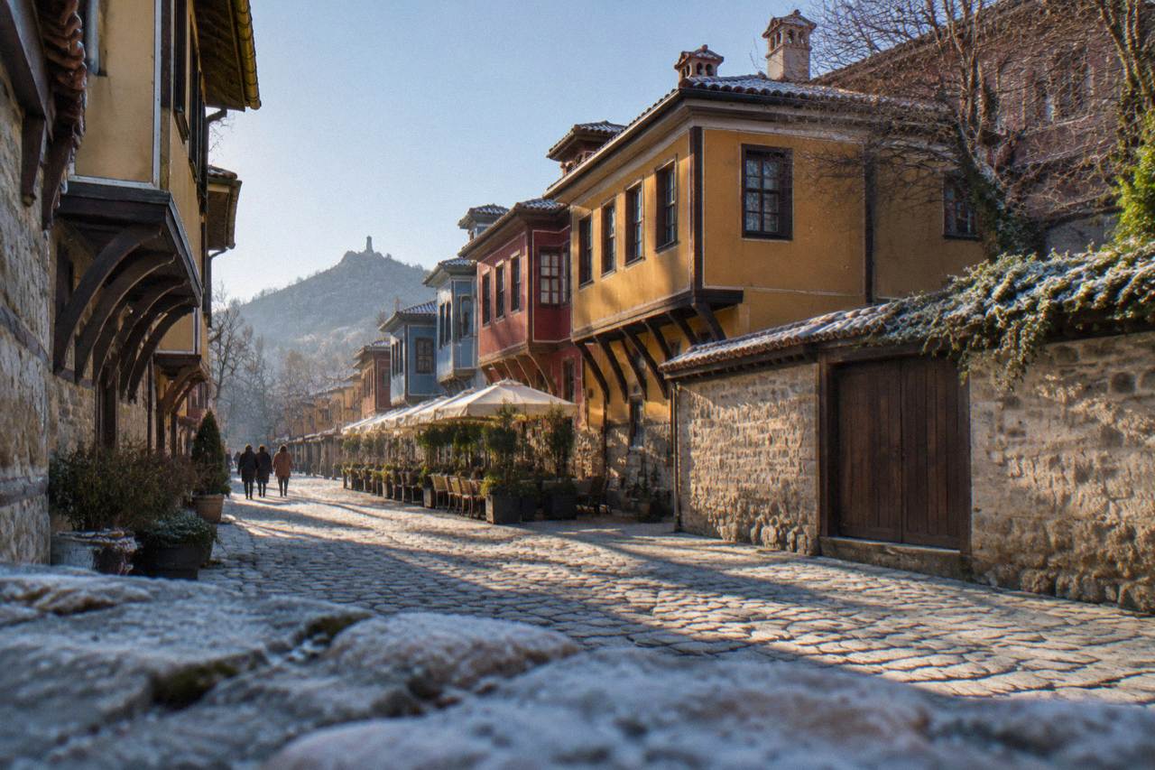 A wide pedestrian street in Plovdiv lined with colourful facades and outdoor cafes