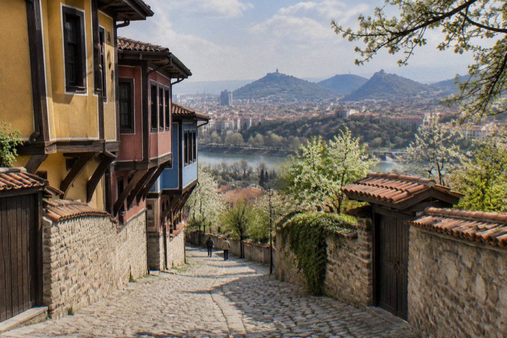 Spring greenery on a Plovdiv hill park with the city skyline behind