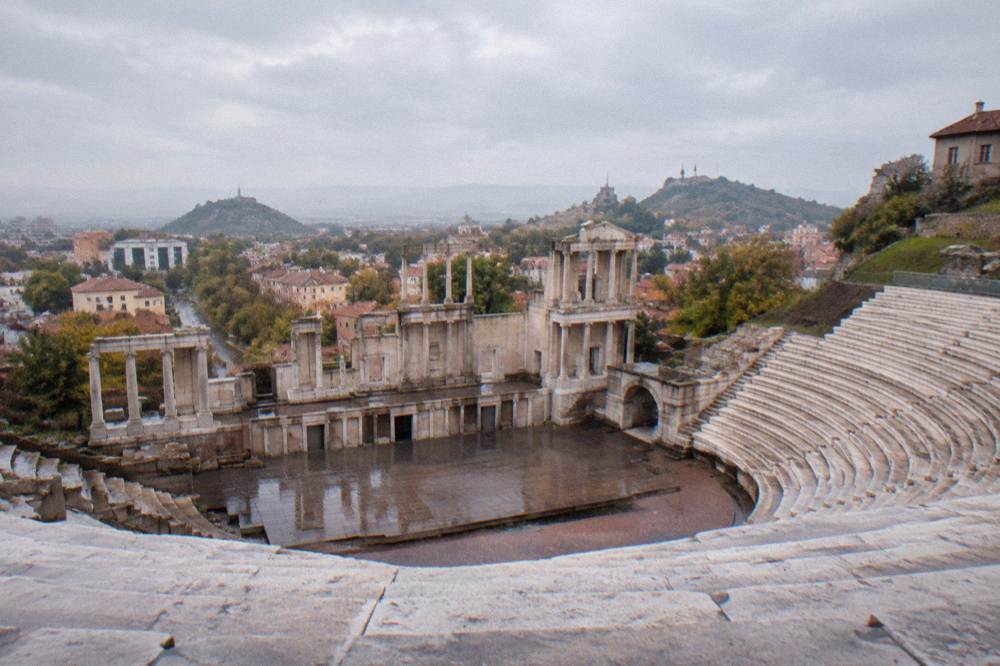 Empty marble rows of the Roman theatre seen from the top seats