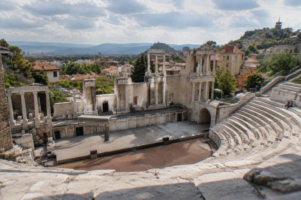 Marble theatre seats in tiers with modern reconstruction visible in places