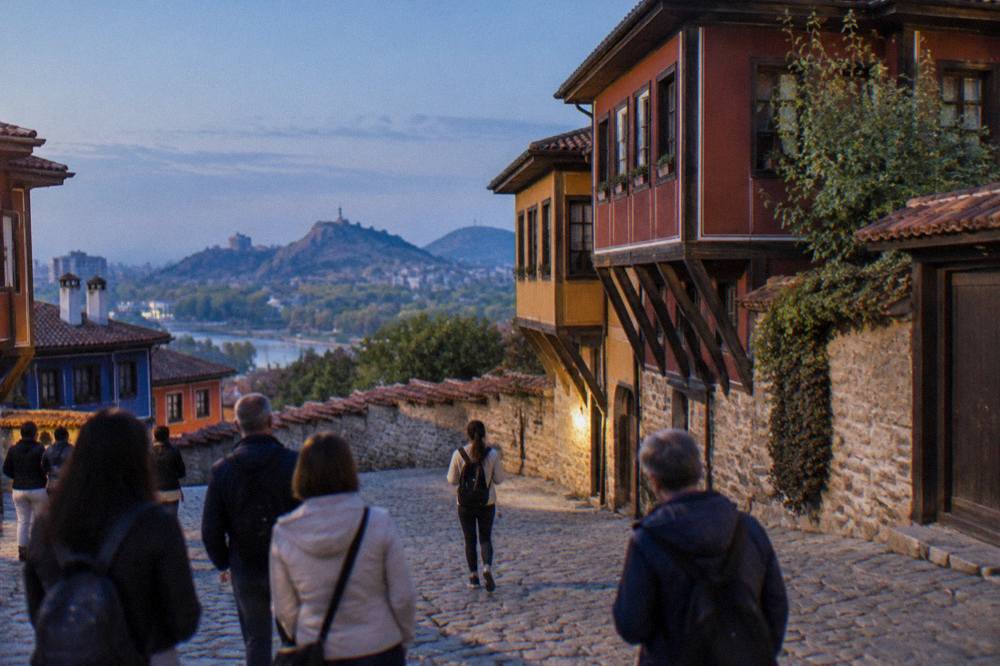 A guided walking group pausing on a cobblestone square in Plovdiv's historic centre