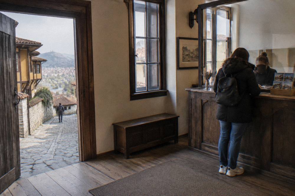 A ticket desk in an Old Plovdiv museum house with brochures and a wooden counter