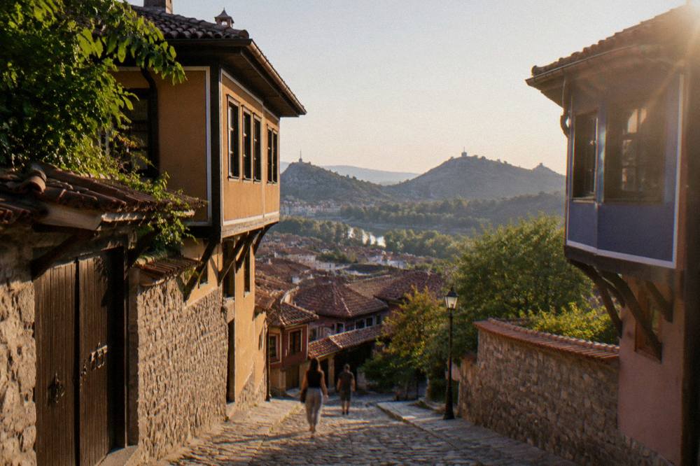 View over red rooftops of Plovdiv Old Town toward the hills beyond