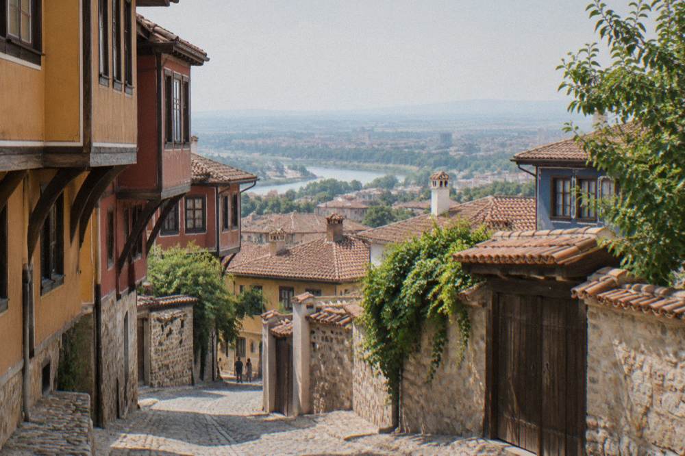 View over red rooftops of Plovdiv Old Town toward the plain beyond