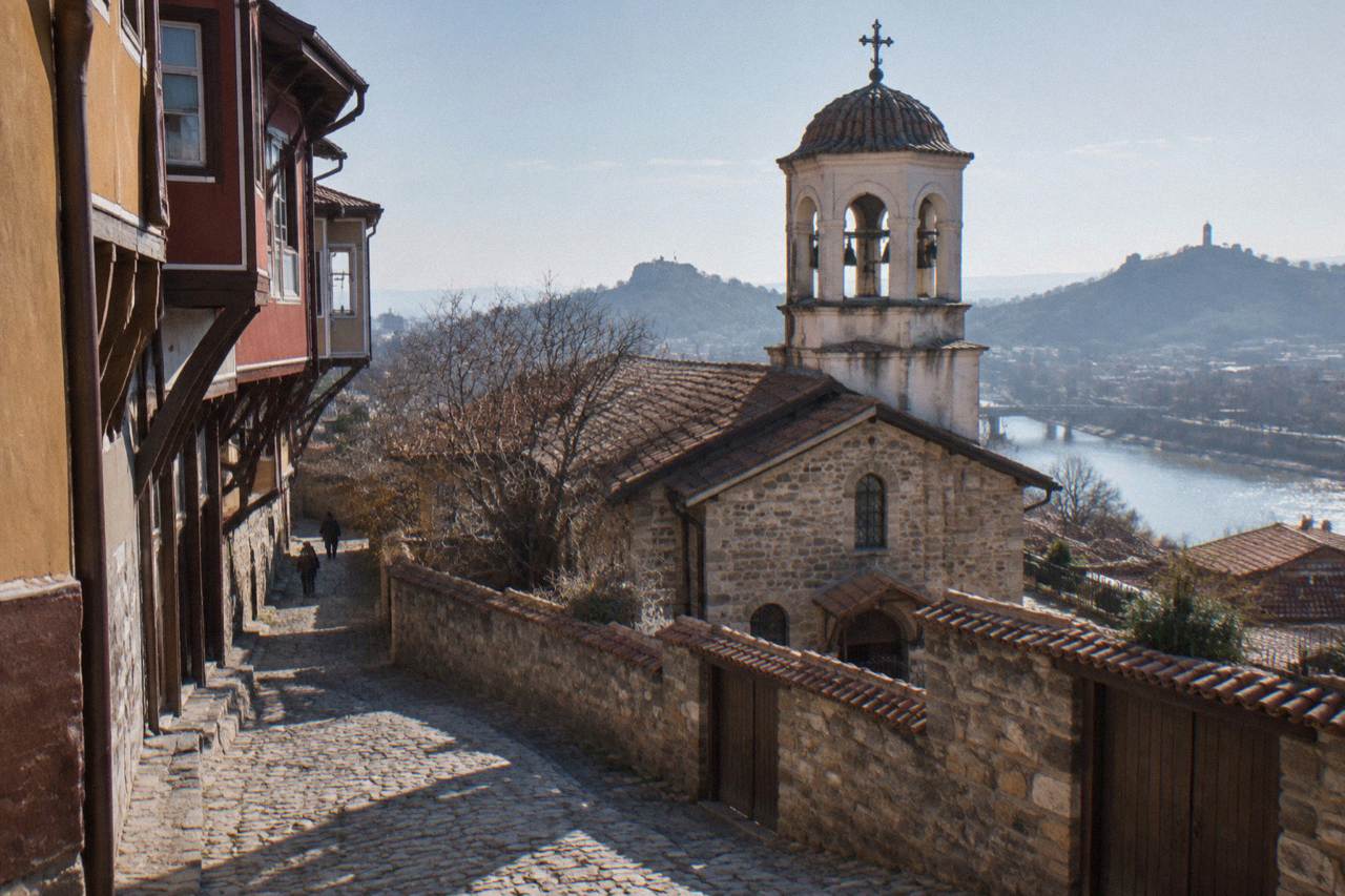 The facade of a small Orthodox church with stone walls and a bell tower in Plovdiv's Old Town