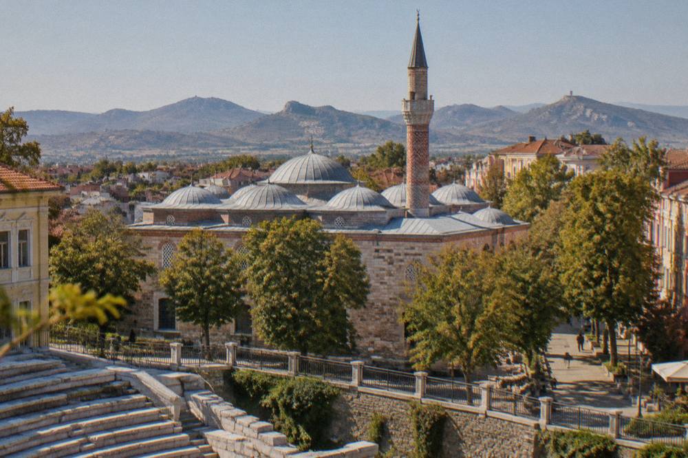 The lead-covered domes and painted minaret of the Dzhumaya Mosque seen from the Roman Stadium sphendone