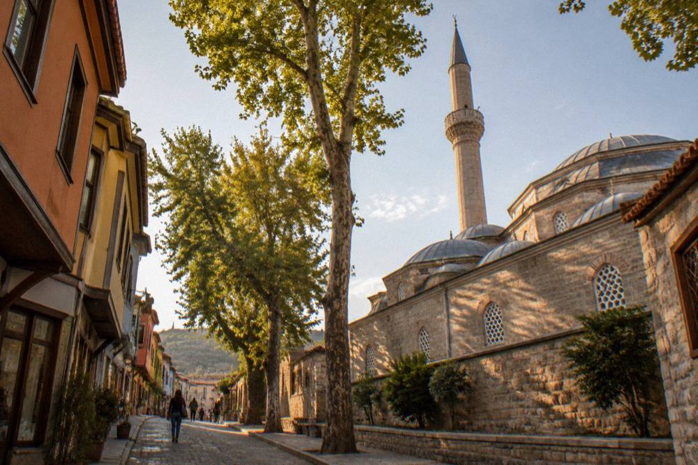 A narrow street in Kapana with painted facades and small shops a short walk from the Dzhumaya Mosque