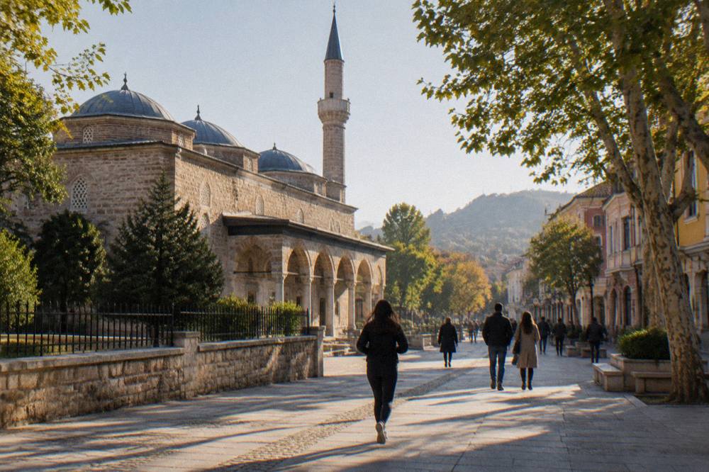 Visitors walking along the Main Street in Plovdiv with the Dzhumaya Mosque on the left