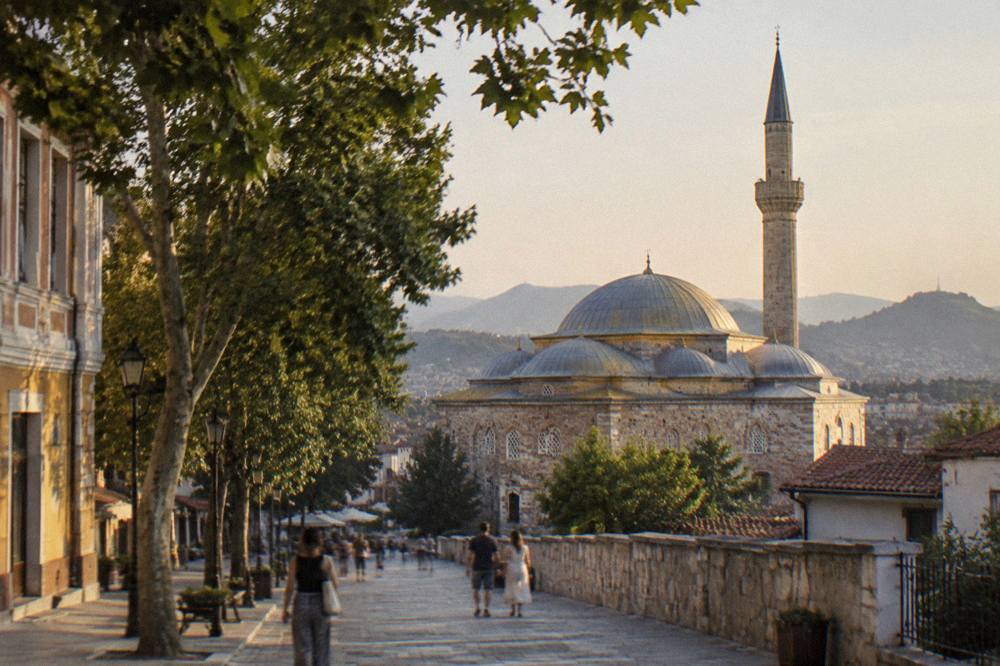 The Dzhumaya Mosque domes glowing in evening light above the pedestrian street in Plovdiv