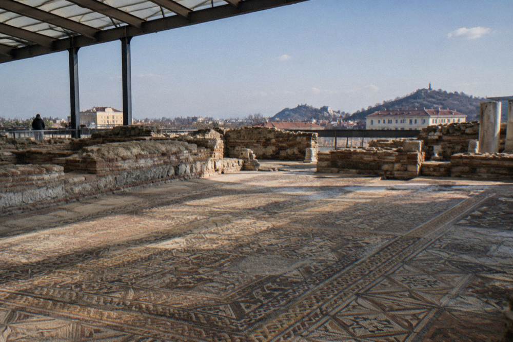 Large floor mosaic panels in a covered basilica ruin