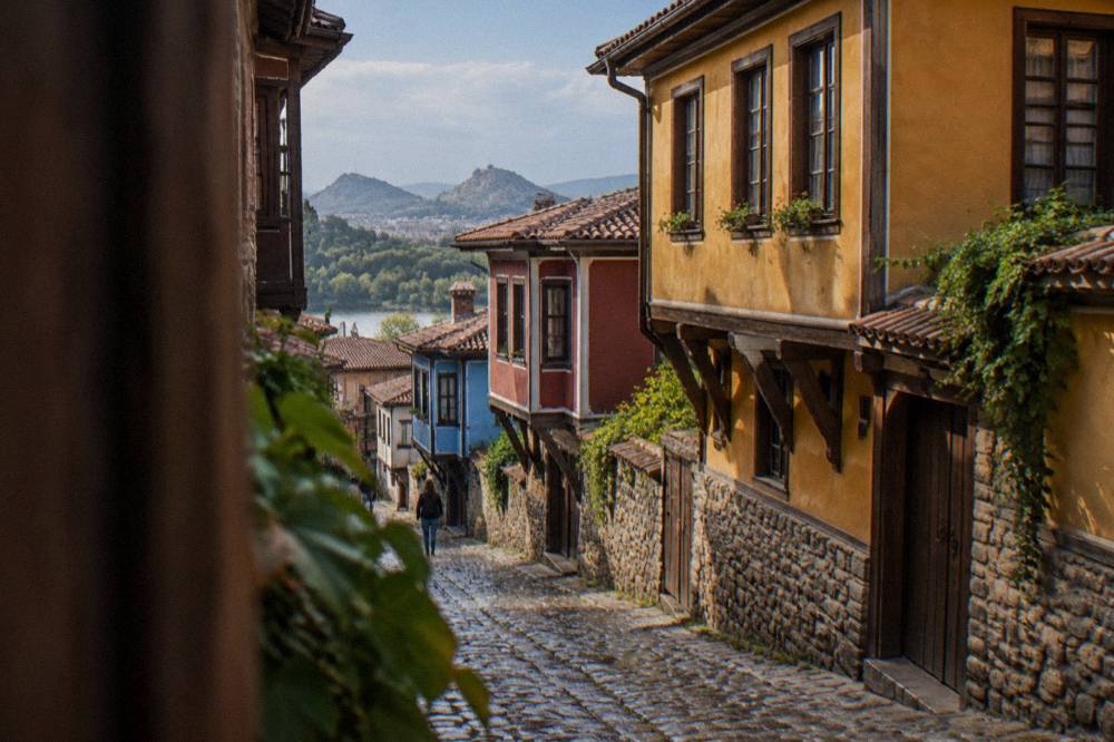A steep cobblestone lane in Plovdiv's Old Town lined with colourful revival-era house facades