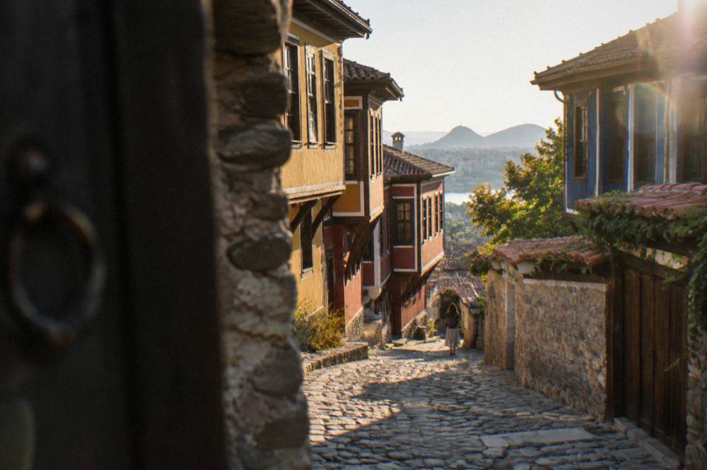 A cobbled lane in Plovdiv Old Town lined with colourful revival period houses on a slope