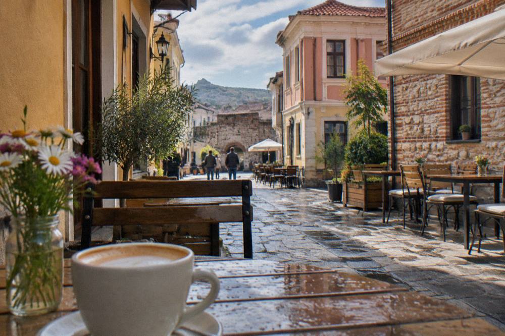 Outdoor tables on a narrow lane in Kapana near Plovdiv's Old Town gate