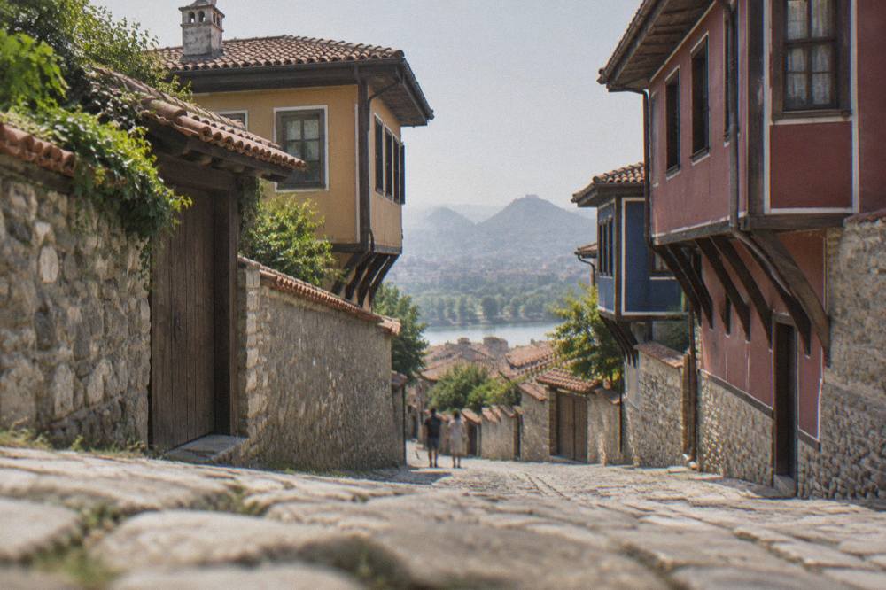 A quiet cobbled lane in Plovdiv Old Town lined with revival-period houses with overhanging upper floors