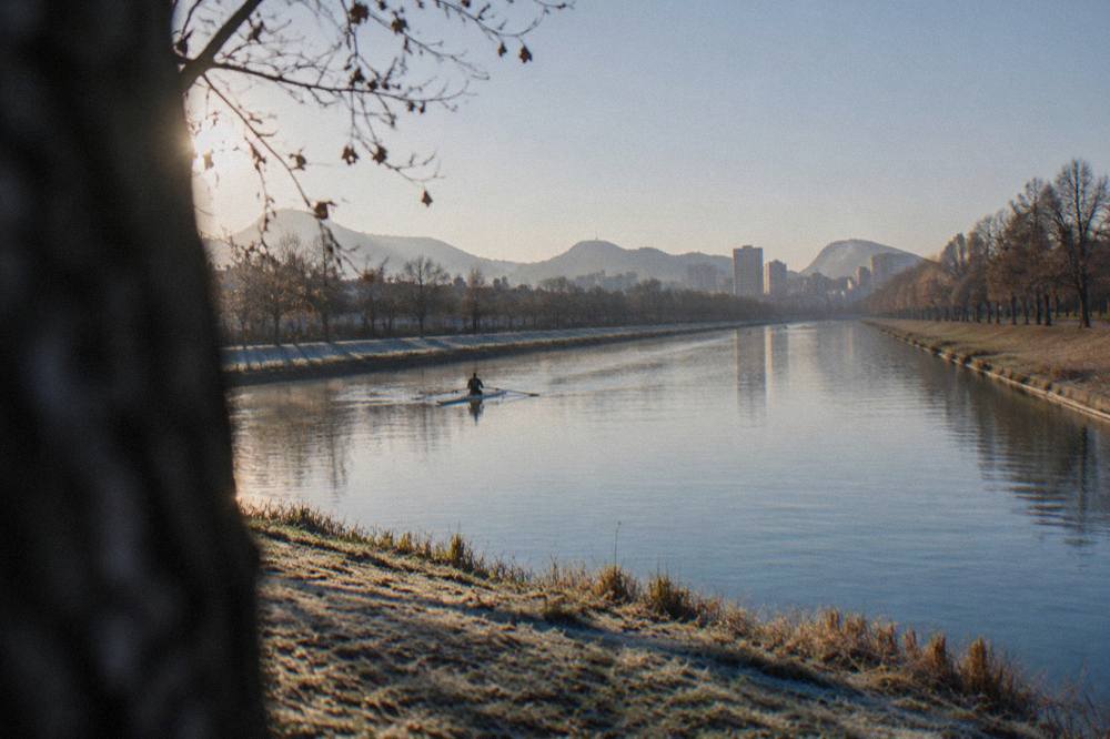 Early morning light on the straight water with the city skyline and hills beyond the banks