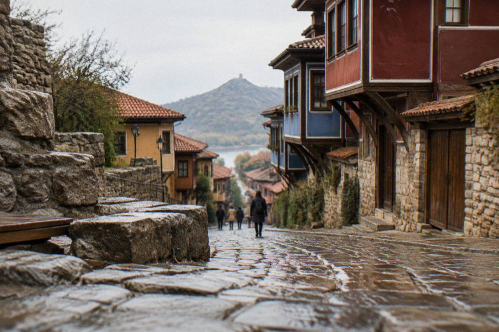 Pedestrian shopping street in Plovdiv with ancient stone ruins visible at the edge of the walkway