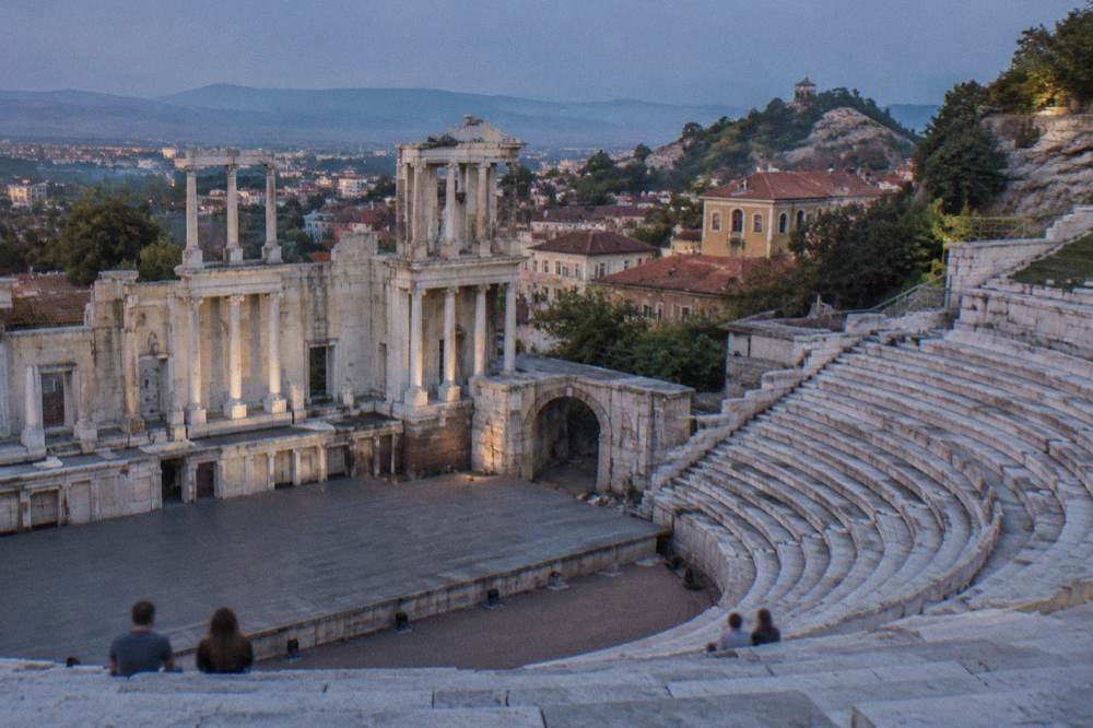 Tiered marble seats of an ancient Roman theatre seen from the stage area
