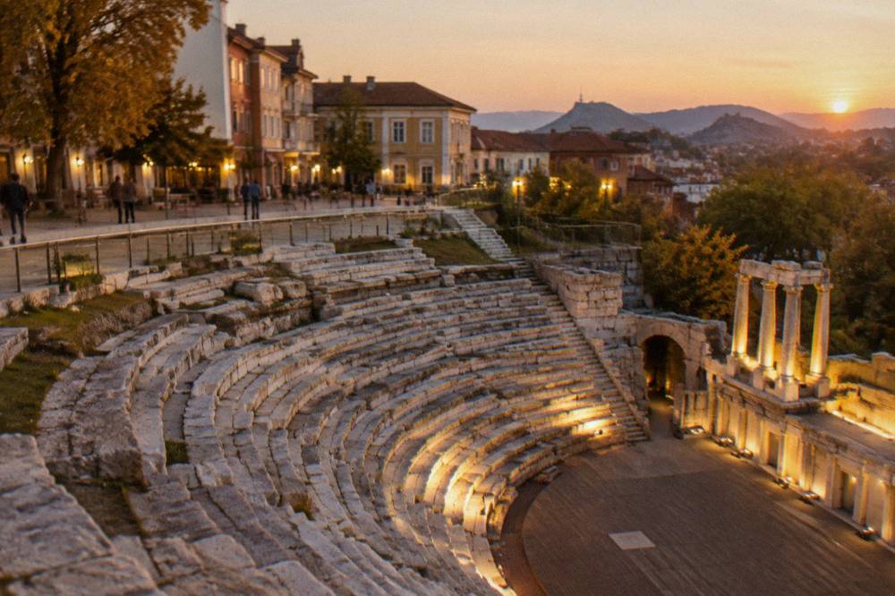 Evening floodlights illuminating the ancient stone seating of the Roman Stadium sphendone in Plovdiv