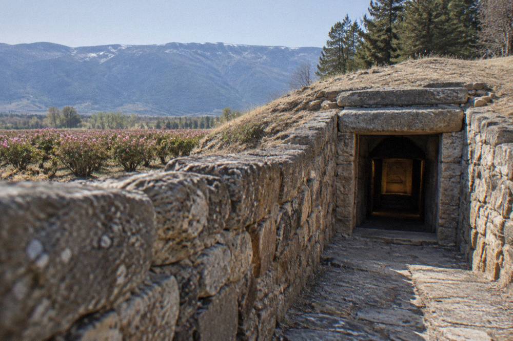 A stone corridor leading into an excavated Thracian tomb chamber