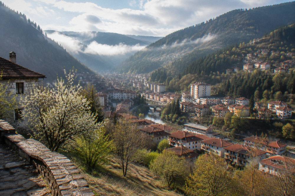 A small valley town with houses among wooded slopes in the Rhodopes