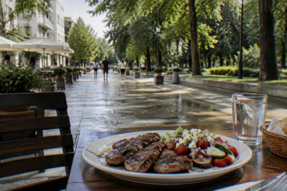 A plate of grilled meat and a fresh salad on a restaurant table outdoors