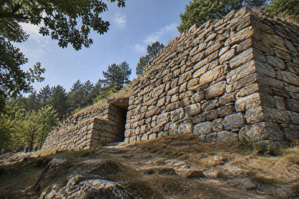 A massive dry-stone wall of a Thracian temple complex seen from below