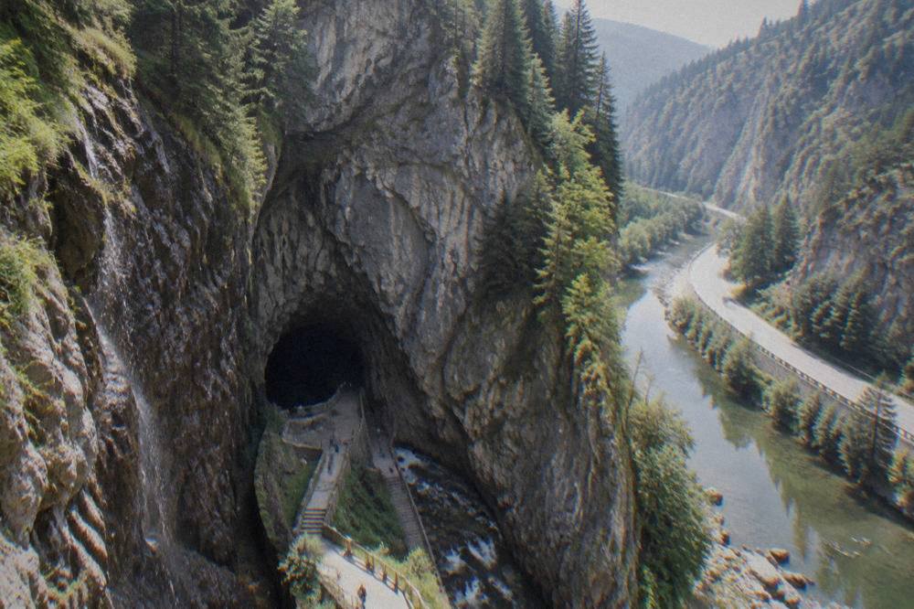 A winding mountain road beside a river inside a steep rocky canyon in the Rhodopes