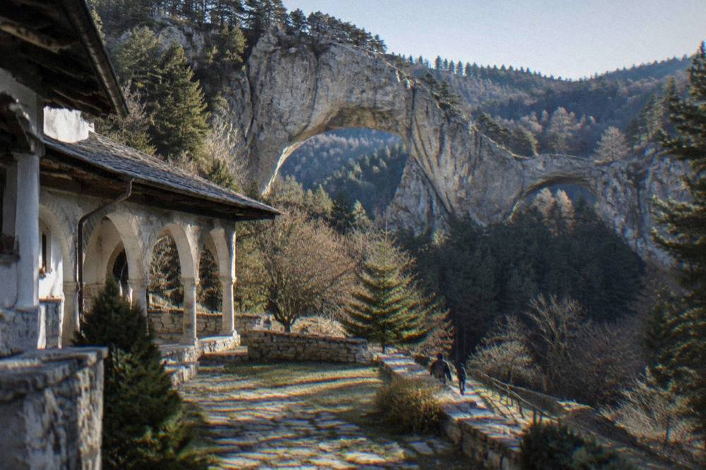 A monastery courtyard with arcades in the green foothills of the Rhodopes