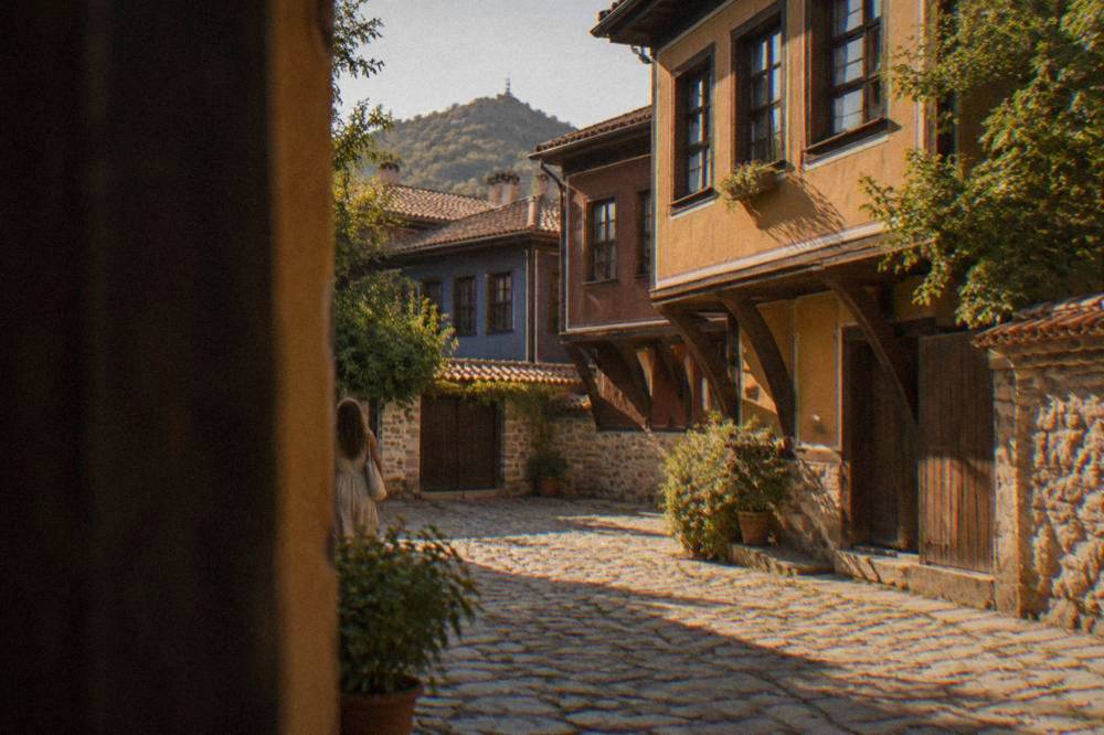 Museum courtyard with cobbles and a traditional wooden house facade in Plovdiv
