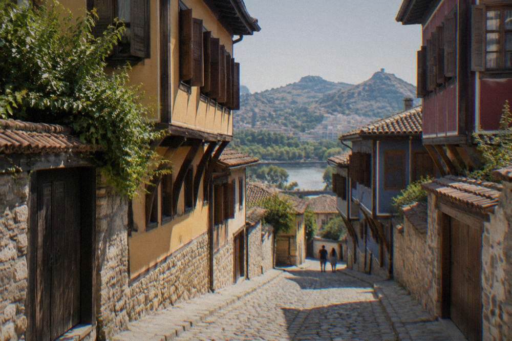 Narrow cobbled lane between old houses with wooden shutters in Plovdiv