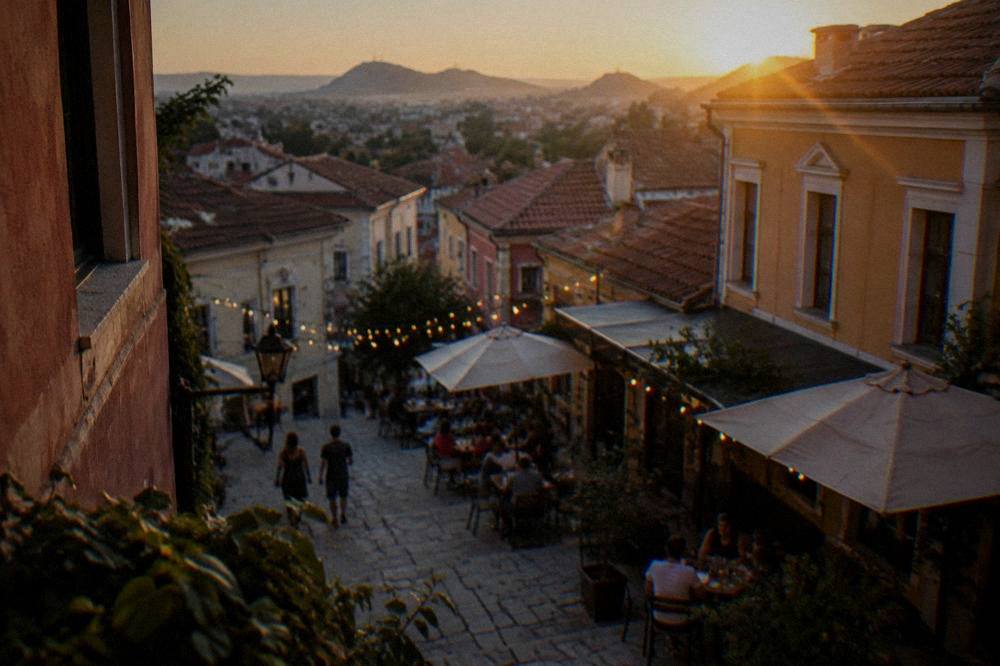 Evening lights over the Kapana creative district with people at outdoor tables
