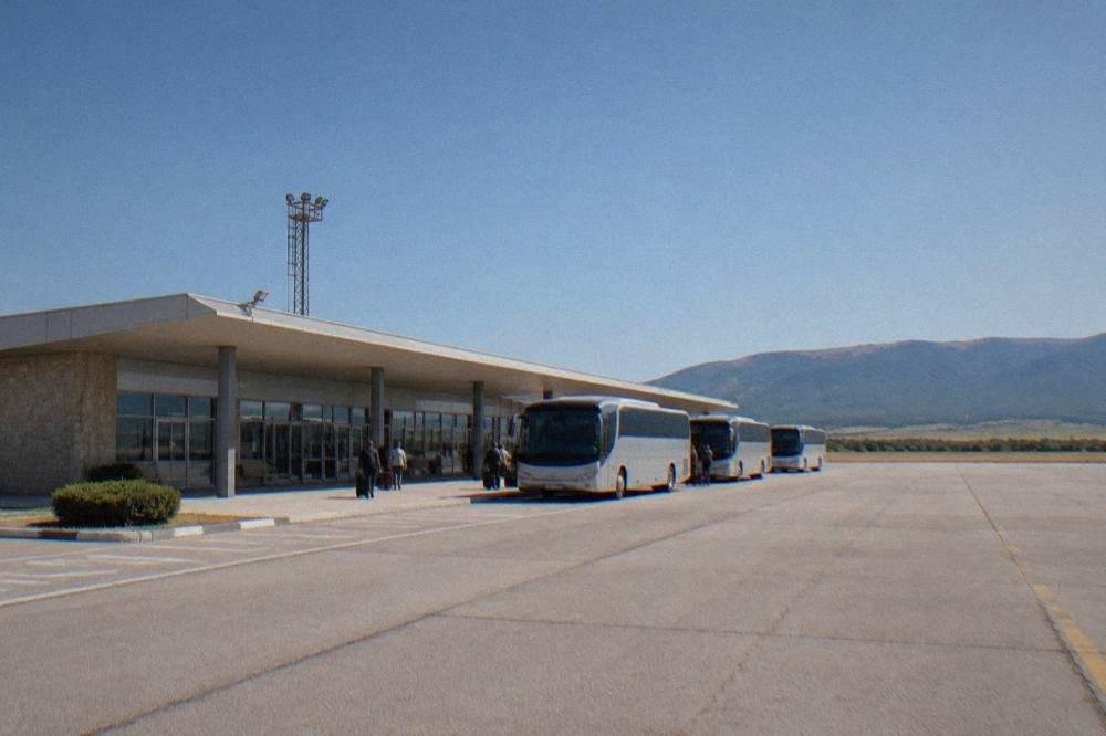 A small regional airport terminal building under a clear sky