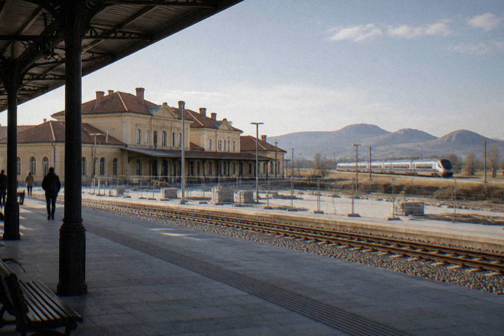 A modern intercity train travelling through open farmland in Bulgaria