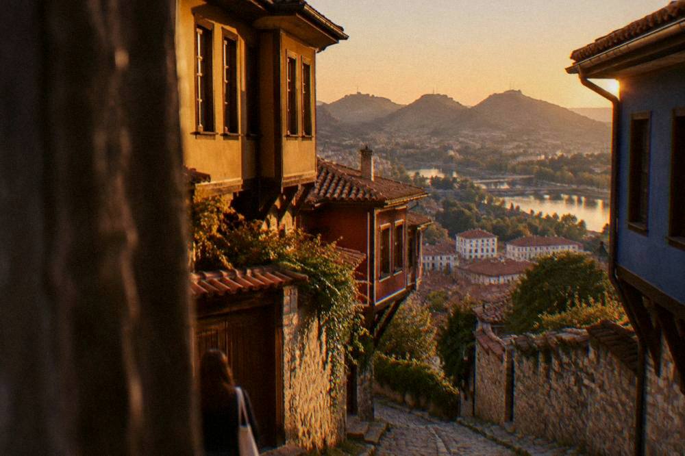 Aerial view of Plovdiv rooftops and hills under evening light
