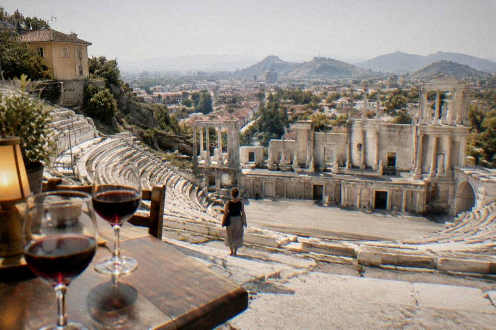 Glasses of red wine on a wooden table in warm lamplight