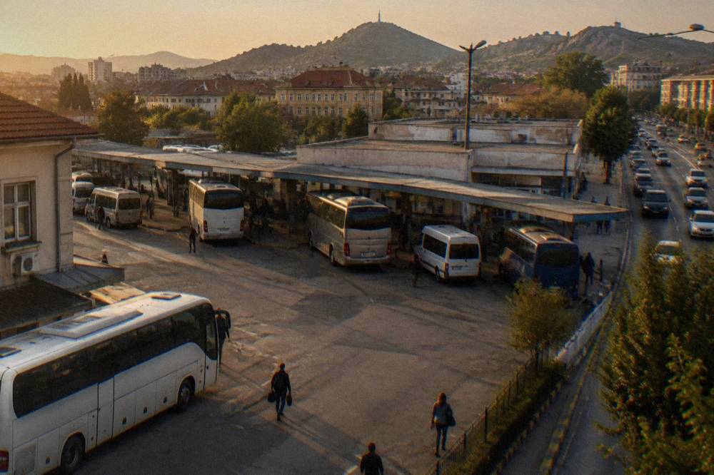 A long-distance coach on a Bulgarian motorway heading toward Plovdiv at dusk