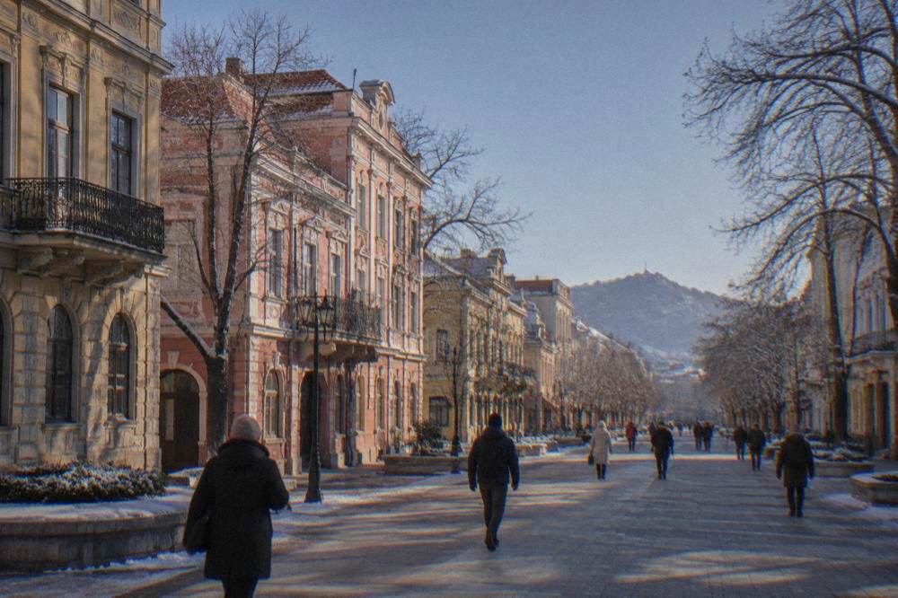 People in winter clothing walking past illuminated historic buildings at night
