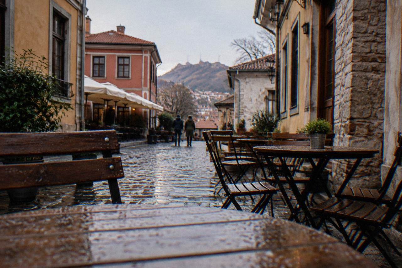 Small tables and chairs on a cobbled street in Plovdiv's Kapana district