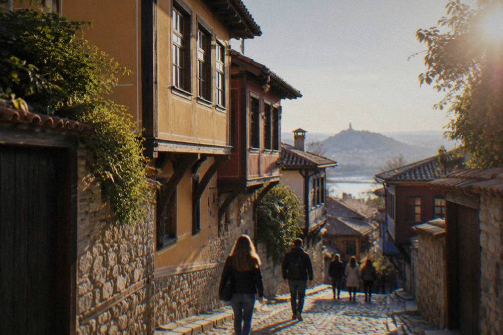 People walking a cobbled street past old houses in Plovdiv Old Town