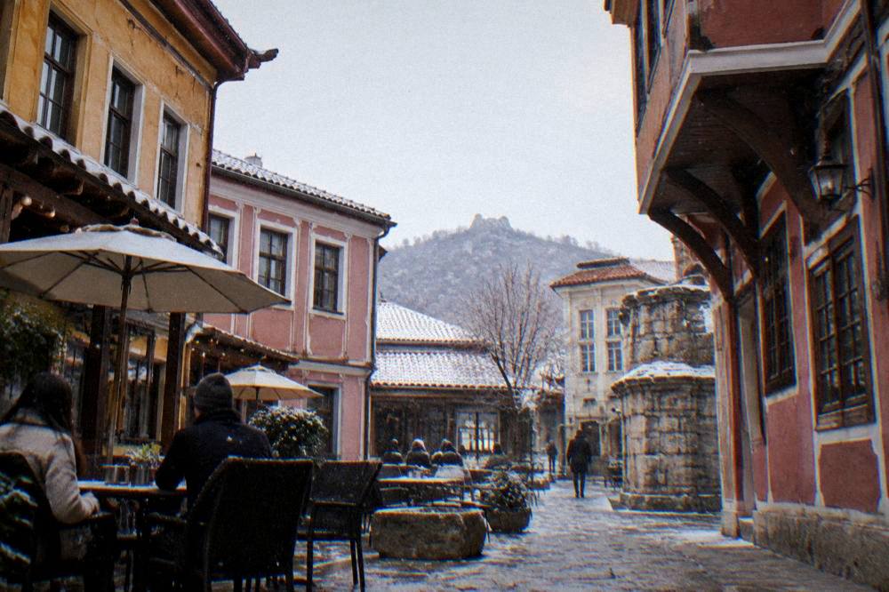 People relaxing at outdoor tables in a courtyard in the Kapana district of Plovdiv