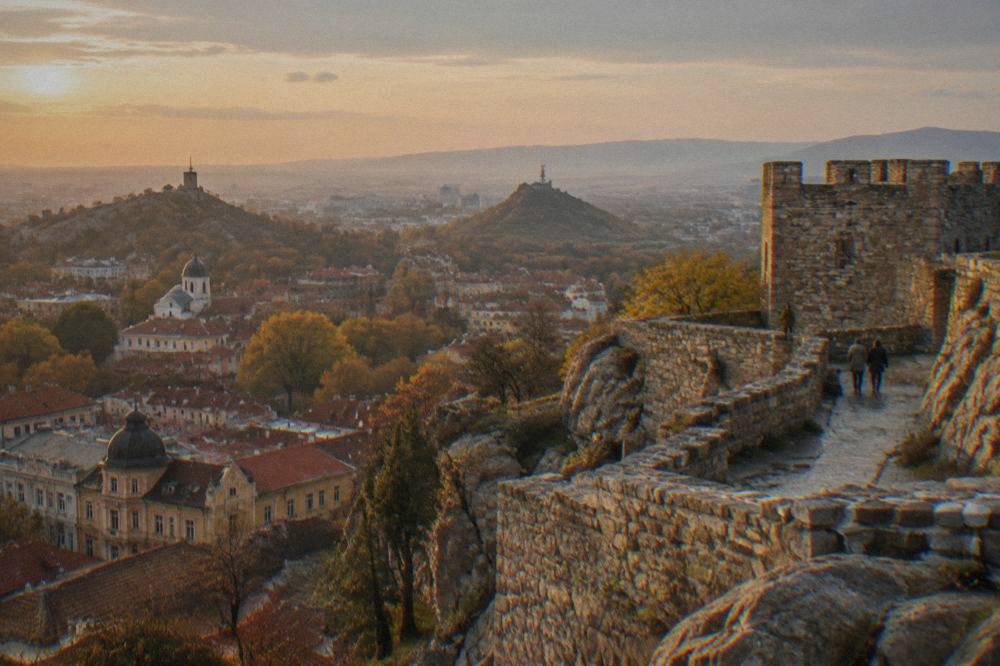 Stone foundations and fortress walls on Nebet Tepe overlooking the city at golden hour