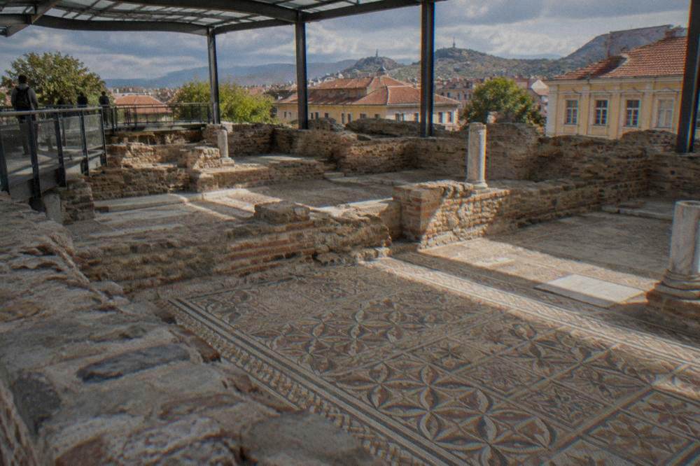 Ancient mosaic floor of the Bishop's Basilica viewed from a raised walkway