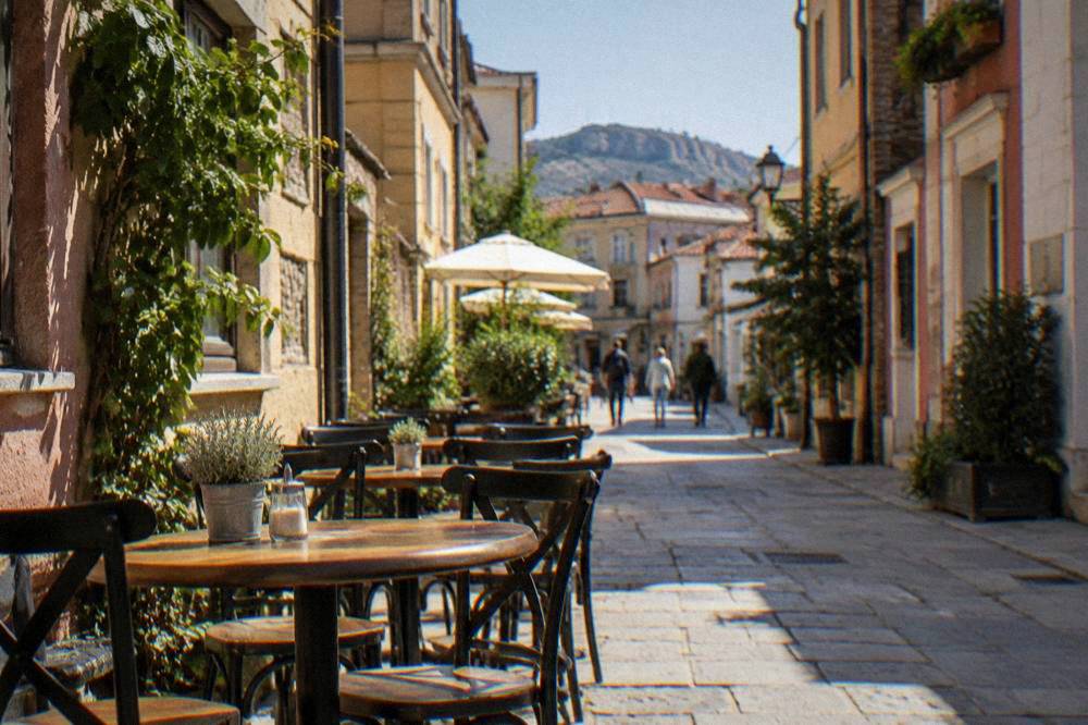 Tables and chairs set out on a narrow street in the Kapana district of Plovdiv